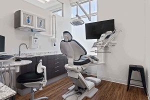 Interior view of Villanova Dental Studio with a dental chair and sink located in Stittsville, ON