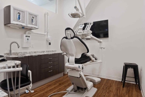 Interior of Villanova Dental Studio in Stittsville, ON, with a dental chair, sink, and desk.