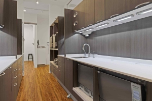 The kitchen area at Villanova Dental Studio in Stittsville, ON, has a sink and refrigerator