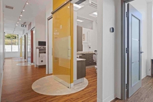 A modern hallway in Villanova Dental Studio, Stittsville, ON, features a kitchen area.
