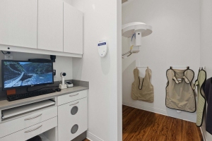 A Small Dental Studio Room Featuring a Computer and Television for Patients in Stittsville, ON