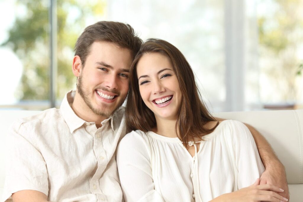 A couple relaxing together on a sofa in a bright living room in Kanata, ON
