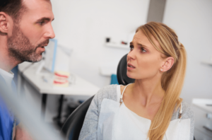 Person seated in dental chair receiving treatment guidance in Kanata, ON
